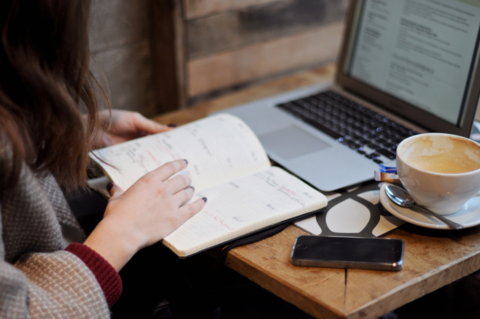 woman planning her tasks in notebook