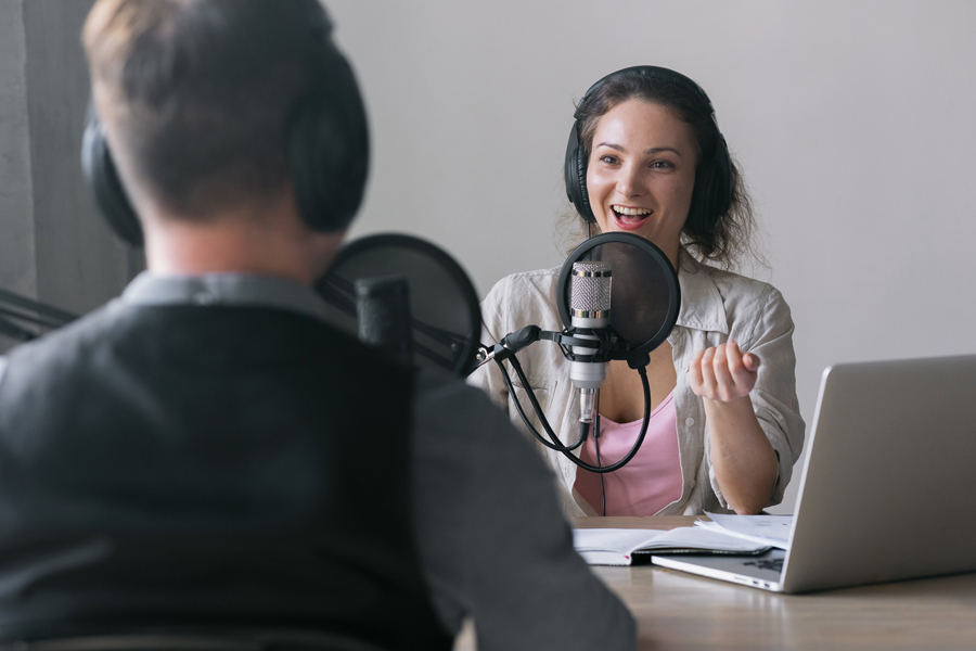 podcast host recording her podcast outro