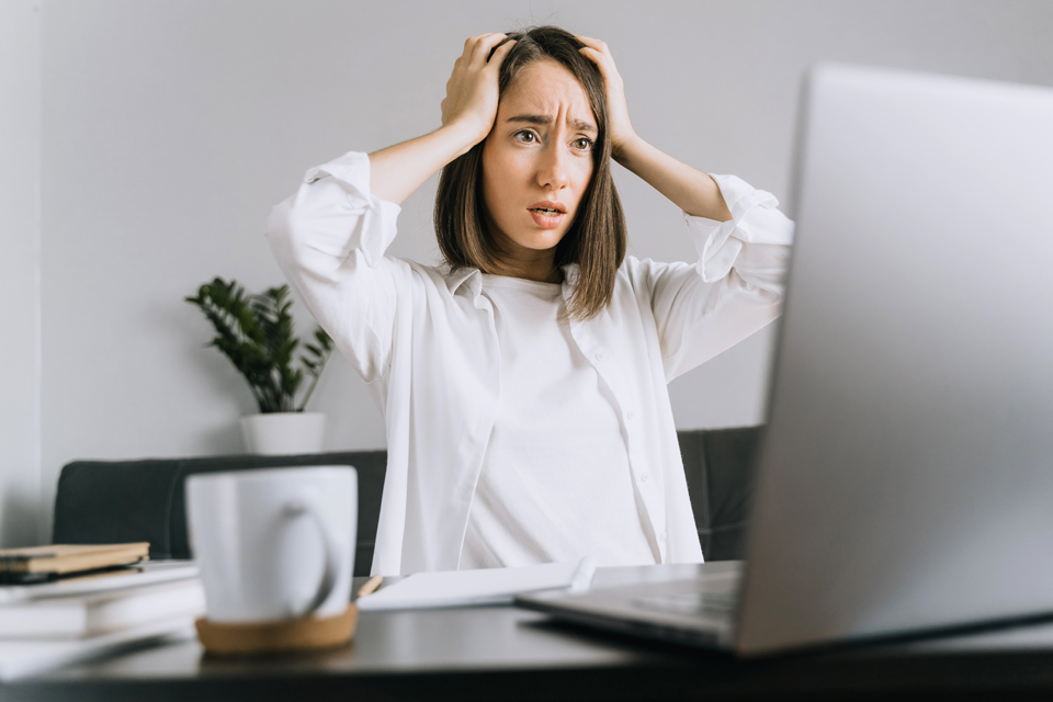 a woman with hands on head