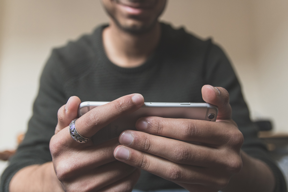 man watching audiograms on his smartphone