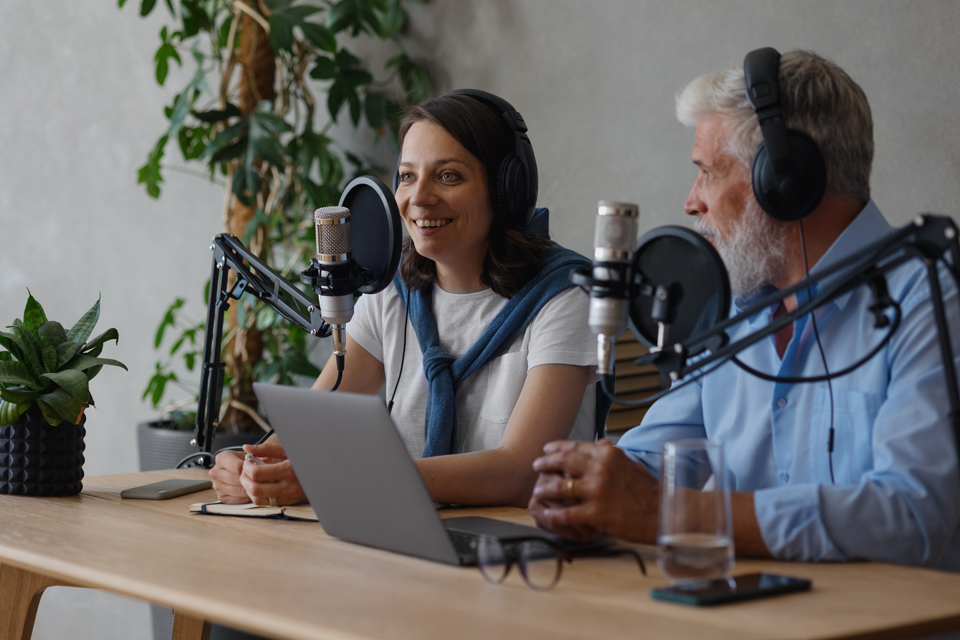 a man and a woman conducting a podcast interview